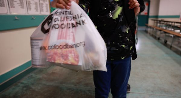 20230701_Yokomi student carring plastic shopping bag full of food
