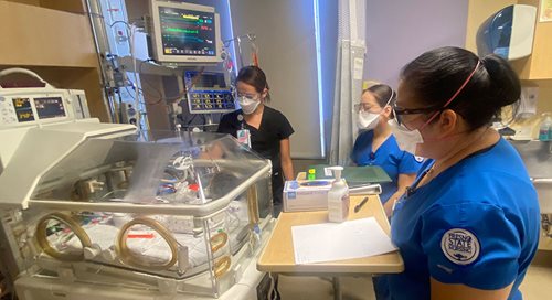 20211027_StudentNurseTraining Three student nurses gather around a NICU patient